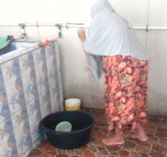 Membersihkan jentik nyamuk di kamar mandi