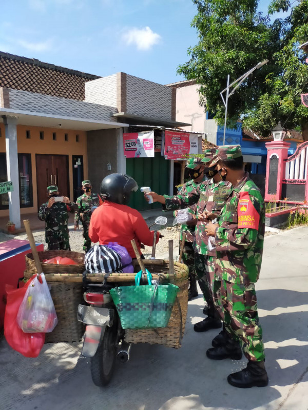 Warga di tes suhu badan dengan termo gun